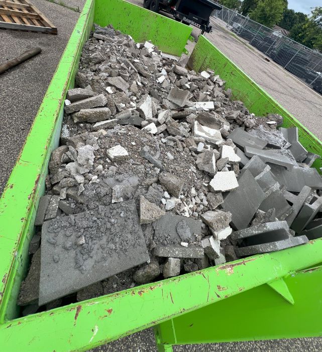 Dumpster filled with concrete debris