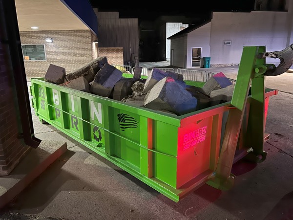 Dumpster filled with cement blocks