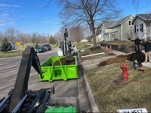 Dumpster filled with landscape soil