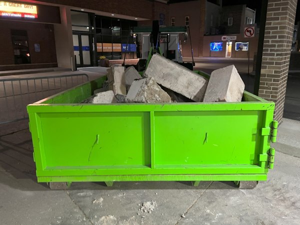 Dumpster filled with concrete blocks